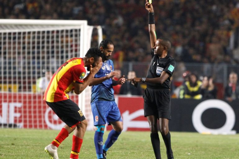 Soccer Football - African Champions League Final - Second Leg - Esperance Sportive de Tunis v Al Ahly - Stade Olympique de Rades, Rades, Tunisia - November 9, 2018 Esperance's Fousseyni Coulibaly is booked by the referee REUTERS/Zoubeir Souissi