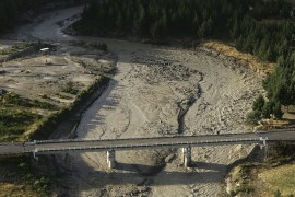 WANGANUI, NEW ZEALAND - MARCH 18: The Lahar flows under the Tangiwai Bridge as it makes its way along the path of the Whangaehu River after breaking the crater wall on Mount Ruapehu on March 18, 2007 in the National Park, New Zealand. The lake levels rose, causing the crater rim to collapse to send the mudflow (Lahar) down the mountain. (Photo by Phil Walter/Getty Images)