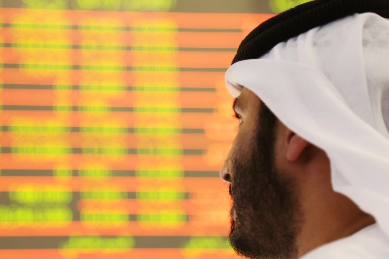 An investor looks at the screen at the Dubai International Financial Market in Dubai, UAE February 7, 2018. REUTERS/Satish Kumar