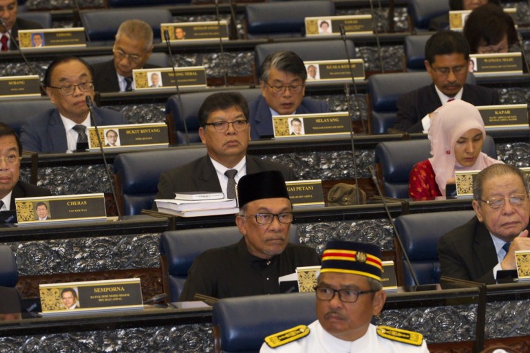 Anwar Ibrahim returned to parliament as a lawmaker- - KUALA LUMPUR, MALAYSIA - OCTOBER 15: Anwar Ibrahim (C) looks on after taking his oath as a Member of Parliament during the swearing-in ceremony at the Parliament House in Kuala Lumpur, Malaysia on October 15, 2018. Anwar Ibrahim wins Parliamentary of Port Dickson seat after it was vacated to enable him to contest as he prepares to ascend to power as part of an agreement within the Pakatan Harapan Coalition (Alliance
