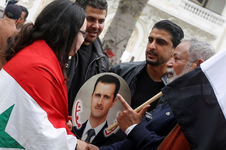People carry Syrian flags and an image of Syria's President Bashar al-Assad as they protest the U.S. military strike against Syria, in Tunis,Tunisia April 8, 2017. REUTERS/Zoubeir Souissi