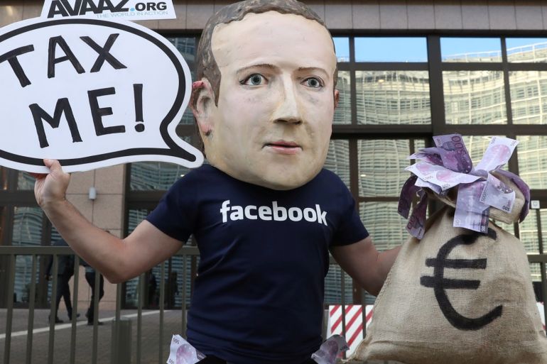 An activist wearing a mask depicting Facebook's CEO Mark Zuckerberg demonstrates during the European Union finance ministers meeting, outside the EU headquarters in Brussels, Belgium, December 4, 2018. REUTERS/Yves Herman TPX IMAGES OF THE DAY