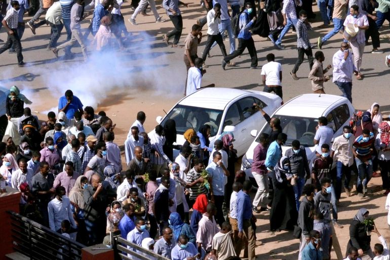 Sudanese demonstrators run from teargas lobbed to disperse them as they march along the street during anti-government protests in Khartoum, Sudan December 25, 2018. REUTERS/Mohamed Nureldin Abdallah