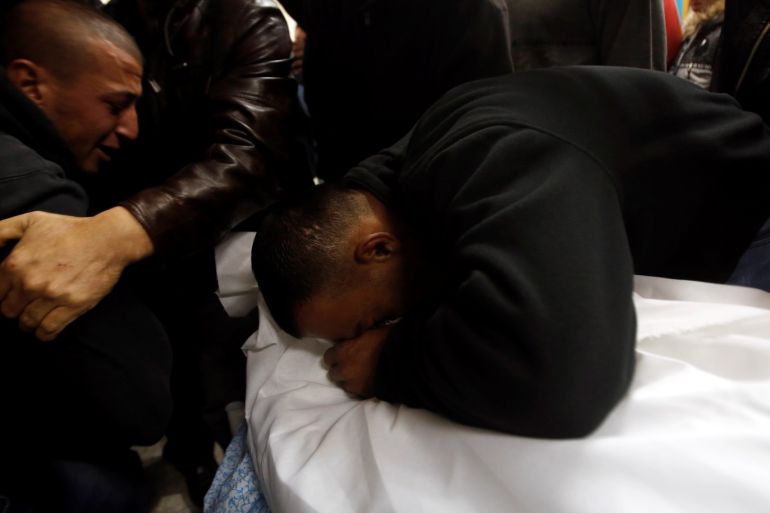 A relative mourns over the dead body of Palestinian man Omar Awad in a hospital in Hebron in the occupied West Bank December 11, 2018. REUTERS/Mussa Qawasma