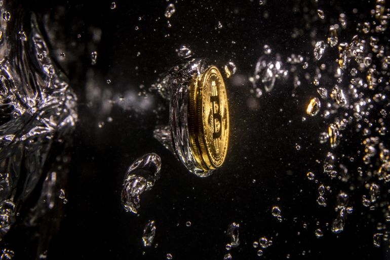 LONDON, ENGLAND - AUGUST 15: (EDITORS NOTE: Image has been rotated 90 degrees.) In this photo illustration a visual representation of the digital currency Bitcoin sinks into water on August 15, 2018 in London, England. Most digital currencies including Bitcoin, (BTC) Ethereum, (ETH) Ripple (XRP) and Stella (XLM) have seen a dramatic fall in their prices throughout 2018 amid a 'mass sell-off'. In December 2017 the price of BTC hit $20,000 USD but has since fallen to around $6000 USD. (Photo Illustration by Dan Kitwood/Getty Images)
