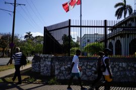 People pass by the Canada's Embassy in Havana, Cuba, April 16, 2018. REUTERS/Alexandre Meneghini