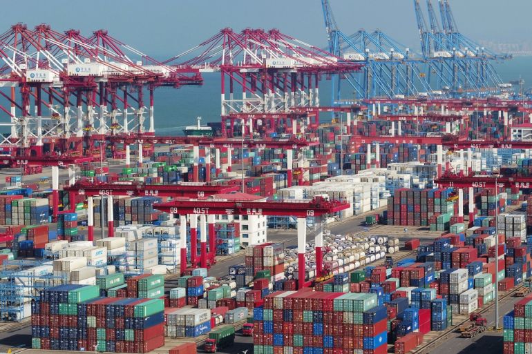 Containers and trucks are seen at a terminal of the Qingdao port in Shandong province, China November 8, 2018. REUTERS/Stringer ATTENTION EDITORS - THIS IMAGE WAS PROVIDED BY A THIRD PARTY. CHINA OUT.