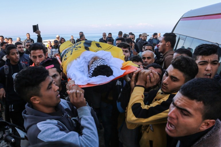 Funeral ceremony of a Palestinian- - DEIR AL BALAH, GAZA - DECEMBER 22: (EDITOR'S NOTE: Image depicts death) Palestinians carry the dead body of Ayman Munir Shbeir, a Palestinian youth succumbed to wounds he sustained from Israeli army gunfire to