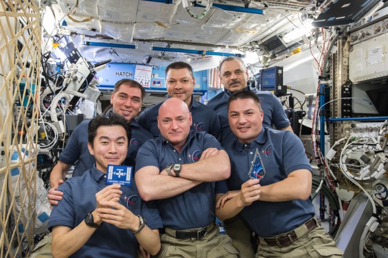The International Space Station Expedition 45 crew gathers inside the Destiny laboratory to celebrate the 15th anniversary of continuous human presence aboard the International Space Station, November 2, 2015. Front row: Japanese astronaut Kimiya Yui (left) and NASA astronauts Scott Kelly (middle) and Kjell Lindgren. Back row: Russian cosmonauts Sergey Volkov (left), Oleg Kononenko (middle) and Mikhail Kornienko (right). REUTERS/NASA/Handout ATTENTION EDITORS - FOR E