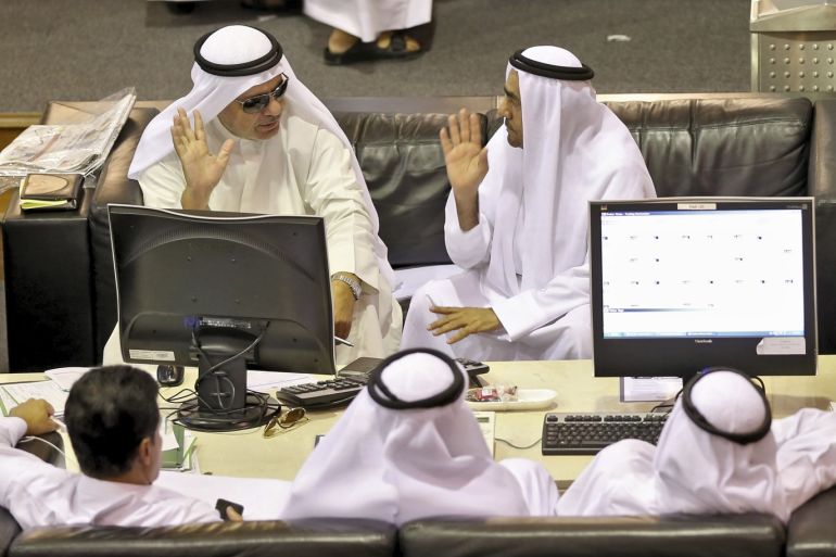 Investors watch a monitor at Dubai Financial Market April 27, 2014. Many professional fund managers and analysts are starting to worry that the market may be overheating; some have been predicting a pull-back for months. But the flood of money from retail investors has pushed the index up almost without interruption for 18 months. Picture taken April 27, 2014. REUTERS/Mounir Saidi (UNITED ARAB EMIRATES - Tags: BUSINESS)