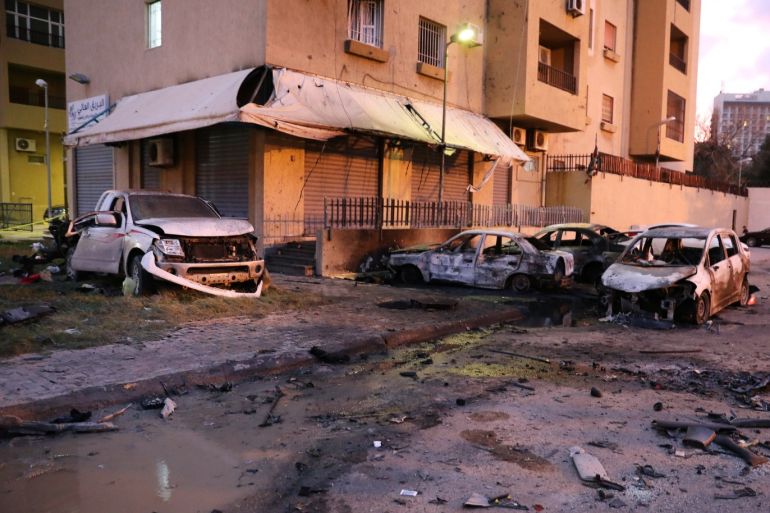 Burned cars are seen at the site of the headquarters of Libya's Foreign Ministry after suicide attackers hit in Tripoli, Libya December 25, 2018. REUTERS/Hani Amara