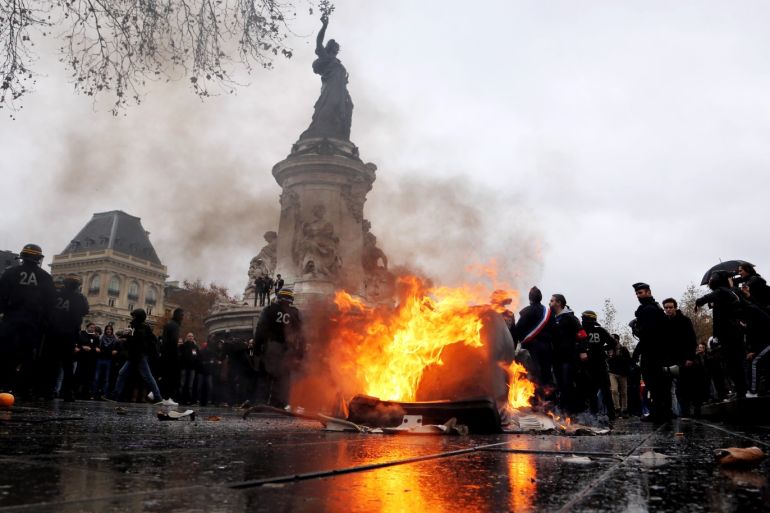 Student protest in Paris- - PARIS, FRANCE - DECEMBER 07: French students burn a trashcan on Place de la Republique as demonstrate against the increase of the subscription fees for foreigners students in Paris, France on December 07, 2018.