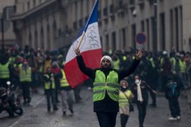PARIS, FRANCE - DECEMBER 08: Protesters march in the 'yellow vests' demonstration near the Arc de Triomphe on December 8, 2018 in Paris France. ''Yellow Vests' ('Gilet Jaunes' or 'Vestes Jaunes') is a protest movement without political affiliation which was inspired by opposition to a new fuel tax. After a month of protests, which have wrecked parts of Paris and other French cities, there are fears the movement has been infiltrated by 'ultra-violent' protesters. Today's protest has involved at least 5,000 demonstrators gathering in the Parisian city centre with police having made over 200 arrests so far. (Photo by Chris McGrath/Getty Images)