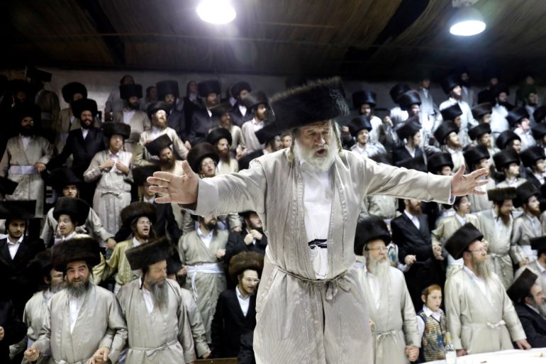 An Ultra-Orthodox Jewish man dances on the table during the celebrations of Simchat Torah in a synagogue at the Mea Shearim neighbourhood of Jerusalem October 1, 2018. REUTERS/Ronen Zvulun