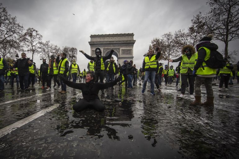PARIS, FRANCE - DECEMBER 01: A protester is wounded by a water canon as they clash with riot police during a 'Yellow Vest' demonstration near the Arc de Triomphe on December 1, 2018 in Paris, France. The third 'Yellow Vest' (gilets jaunes) rally in Paris over increased fuel taxes and leadership in the government today caused over 150 arrests in the city with reports of injuries to protesters and security forces from violence that irrupted from the clashes. (Photo by Veronique de Viguerie/Getty Images)