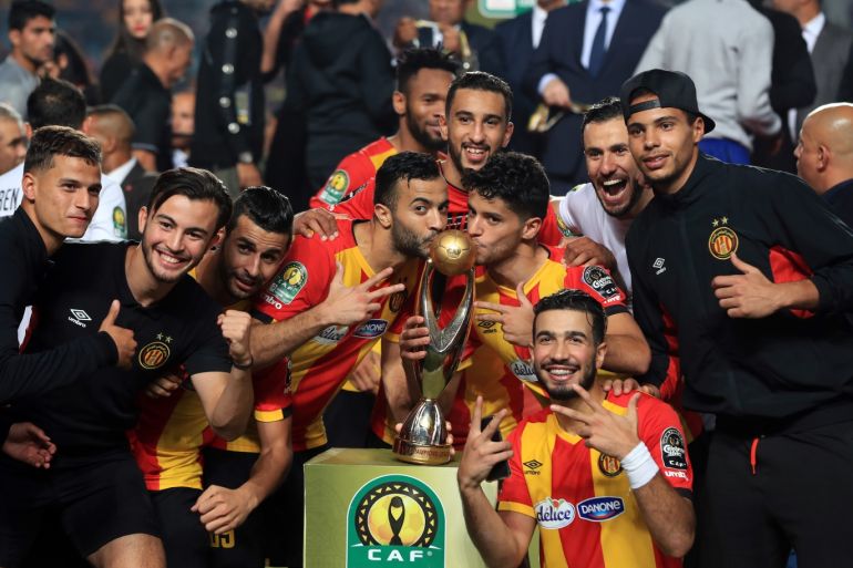 CAF Champions League - Final- - TUNIS, TUNISIA - NOVEMBER 10: Football players of ES Tunis celebrate with a trophy after they won the CAF Champions League second leg final football match against Egypt's Al-Ahly at the Rade Olympic Stadium in Tunis, Tunisia on November 10, 2018.