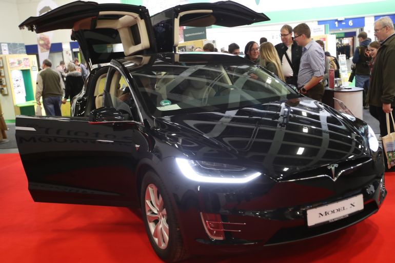 BERLIN, GERMANY - JANUARY 19: Visitors check out a Tesla Model X electric car at the 2018 International Green Week (Internationale Gruene Woche) agricultural trade fair on January 19, 2018 in Berlin, Germany. The International Green Week is among the world's biggest agricultural trade fairs and brings together agriculture, food, nutrition and horticulture. It is open to the public from January 19-28. (Photo by Sean Gallup/Getty Images)