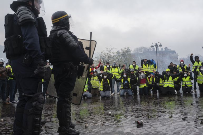 PARIS, FRANCE - DECEMBER 01: Teargas surrounds protesters as they clash with riot police during a 'Yellow Vest' demonstration near the Arc de Triomphe on December 1, 2018 in Paris, France. The third 'Yellow Vest' (gilets jaunes) rally in Paris over increased fuel taxes and leadership in the government today caused over 150 arrests in the city with reports of injuries to protesters and security forces from violence that irrupted from the clashes. (Photo by Veroniqu