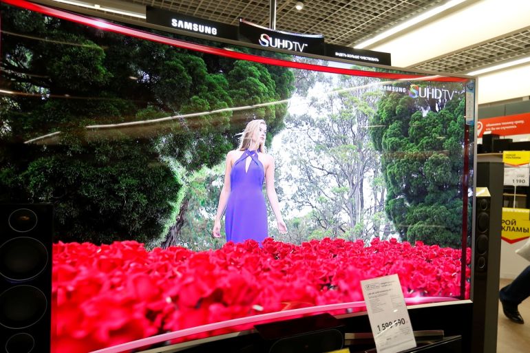 A customer walks past a Samsung S'UHD smart TV in a store of Russia's biggest electrical and white goods retailer M.video in Moscow, Russia, April 15, 2016. REUTERS/Maxim Zmeyev