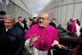 The acting Latin Patriarch of Jerusalem Pierbattista Pizzaballa waves as he arrives through an Israeli checkpoint to attend Christmas celebrations in Bethlehem, in the Israeli-occupied West Bank December 24, 2018. REUTERS/Mussa Qawasma TPX IMAGES OF THE DAY