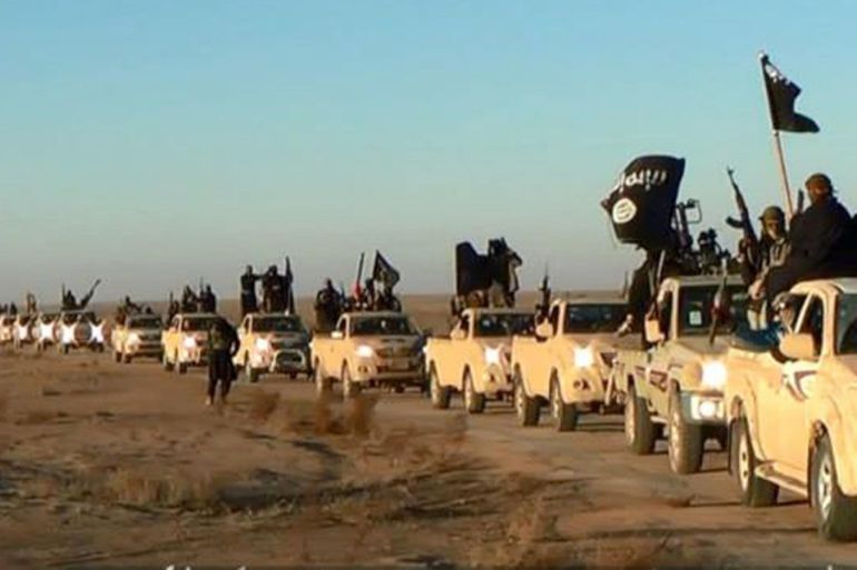 FILE - This file image posted on a militant website on Tuesday, Jan. 7, 2014, which is consistent with AP reporting, shows a convoy of vehicles and fighters from the al-Qaida linked Islamic State of Iraq and the Levant (ISIL) fighters in Iraq's Anbar Province. The Islamic State group holds roughly a third of Iraq and Syria, including several strategically important cities like Fallujah and Mosul in Iraq and Raqqa in Syria. It rules over a population of several million people with its strict interpretation of Islamic law. (AP Photo via militant website, File)