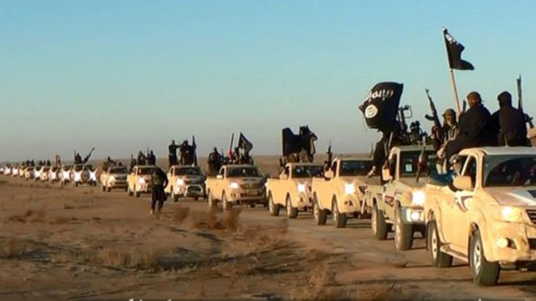 FILE - This file image posted on a militant website on Tuesday, Jan. 7, 2014, which is consistent with AP reporting, shows a convoy of vehicles and fighters from the al-Qaida linked Islamic State of Iraq and the Levant (ISIL) fighters in Iraq's Anbar Province. The Islamic State group holds roughly a third of Iraq and Syria, including several strategically important cities like Fallujah and Mosul in Iraq and Raqqa in Syria. It rules over a population of several million people with its strict interpretation of Islamic law. (AP Photo via militant website, File)