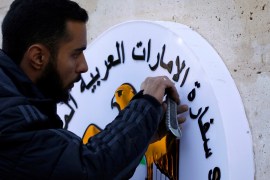 A man works on the United Arab Emirates embassy emblem during its reopening in Damascus, Syria December 27, 2018. REUTERS/Omar Sanadiki