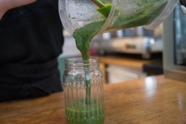 BERLIN, GERMANY - JANUARY 27: An employee prepares a vegan smoothie with spinach and banana at vegan cafe No Milk Today on January 27, 2018 in Berlin, Germany. No Milk Today offers among other self made vegan cakes and pies, smoothies, and breakfast. Since vegan and vegetarian food is a growing trend, more and more stores are specializing in pure herbal products as an alternative to conventional food. (Photo by Steffi Loos/Getty Images)