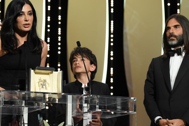 CANNES, FRANCE - MAY 19: Actor Zain Alrafeea (C) looks on as Director Nadine Labaki receives the Jury Prize award for 'Capharnaum' as her producer and husband Khaled Mouzanar (R) watches her on stage during the Closing Ceremony at the 71st annual Cannes Film Festival at Palais des Festivals on May 19, 2018 in Cannes, France. (Photo by Pascal Le Segretain/Getty Images)