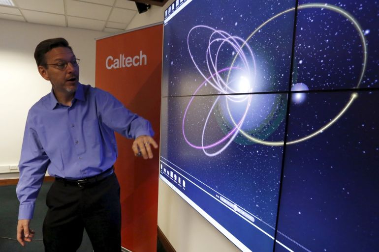 Professor of Planetary Astronomy Mike Brown speaks in front of a computer simulation of the probable orbit of Planet Nine (yellow) at the California Institute of Technology in Pasadena, California January 20, 2016. The solar system may host a ninth planet that is about 10 times bigger than Earth and orbiting far beyond Neptune, according to research published on Wednesday. REUTERS/Mario Anzuoni