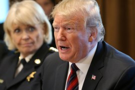 U.S. President Donald Trump speaks while Chester County, Pennsylvania Sheriff Bunny Welsh listens as the president hosts a