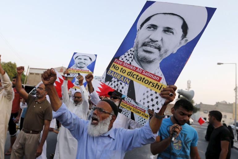 Protesters hold placards with photos of opposition leader and head of Al Wefaq party, Ali Salman, during a protest in the village of Karzakan south of Manama, Bahrain, October 3, 2015. REUTERS/Hamad I Mohammed