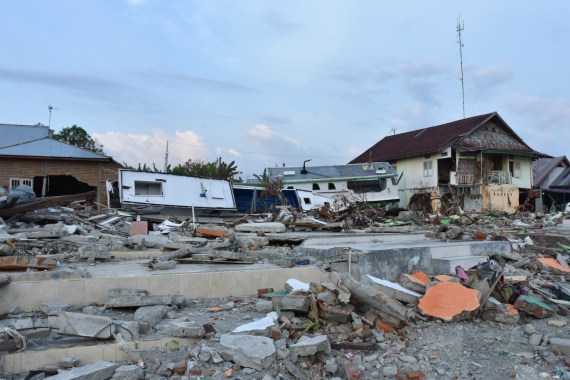 Aftermath of earthquake and tsunami waves in Indonesia- - PALU, INDONESIA - OCTOBER 16: A vessel is stranded on the land near damaged houses after the 7.4 magnitude earthquake and tsunami waves hit the city of Palu, Central Sulawesi, Indonesia on October 16, 2018.
