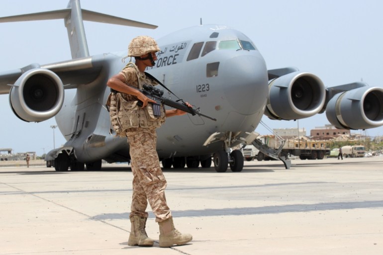A soldier from the United Arab Emirates stands guard next to a UAE military plane at the airport of Yemen's southern port city of Aden August 8, 2015. Soldiers from the United Arab Emirates, at the head of a Gulf Arab coalition fighting Iran-allied Houthi forces in Yemen, are preparing for a long, tough ground war from their base in the southern port of Aden. Picture taken August 8, 2015. REUTERS/Nasser Awad