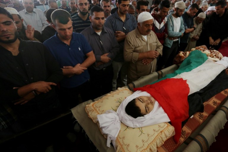 Funeral ceremony of Palestinian child in Gaza Strip- - GAZA CITY, GAZA - NOVEMBER 03: (EDITOR'S NOTE: Image depicts death) Relatives of Palestinian Mohammad Nasr er-Riyfi who injured in Israeli airstrikes four years ago, carry the dead body of him during his funeral ceremony in Gaza City, Gaza on November 03, 2018. Mohammad Nasr er-Riyfi died at the Vafa Hospital.