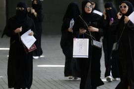 Saudi students walk at the exhibition to guide job seekers at Glowork Women's Career Fair in Riyadh, Saudi Arabia October 2, 2018. REUTERS/Faisal Al Nasser