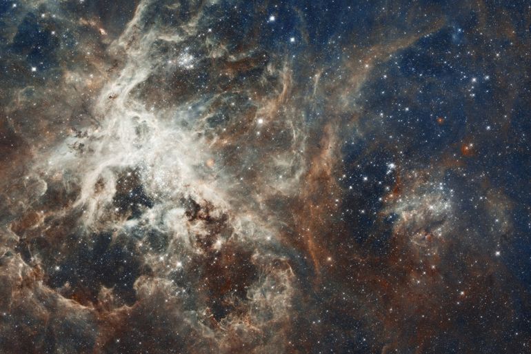 A NASA Hubble Space Telescope composite image shows a stellar breeding ground in 30 Doradus, located in the heart of the Tarantula Nebula 170,000 light-years away in the Large Magellanic Cloud, a small, satellite galaxy of our Milky Way, in this handout photo released on April 17, 2012. The Hubble telescope imaged 30 separate fields with its Wide Field Camera 3 and Advanced Camera for Surveys during October 2011. 30 Doradus is the brightest star-forming region visible i
