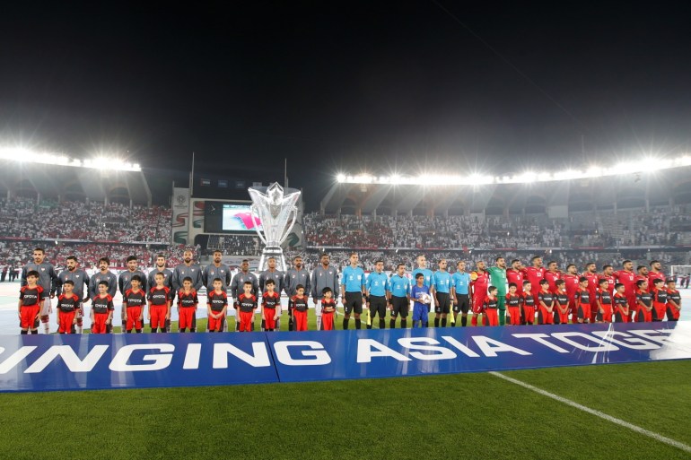 epa07264020 Referees and players pose before the 2019 AFC Asian Cup group A preliminary round match between UAE and Bahrain in Abu Dhabi, United Arab Emirates, 05 January 2019. EPA-EFE/ALI HAIDER