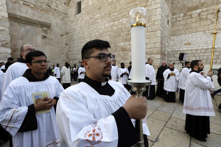 Clergymen attend Christmas celebrations at Manger Square outside the Church of the Nativity in the West Bank city of Bethlehem, 24 December 2018.