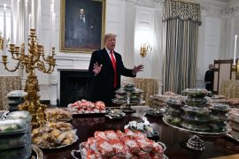 Jan 14, 2019; Washington, DC, USA; President Donald Trump looks over tables of fast food for the the college football playoff champion Clemson Tigers in the State Dining Room of the White House. Mandatory Credit: Brad Mills-USA TODAY Sports