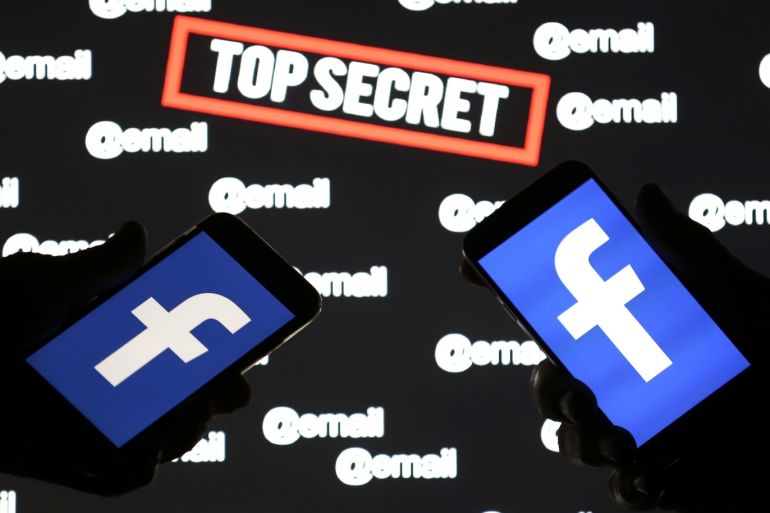 Persons hold smartphones with the Facebook logo in front of displayed "top secret" and "email" words in this picture illustration taken December 6, 2018. REUTERS/Dado Ruvic/Illustration