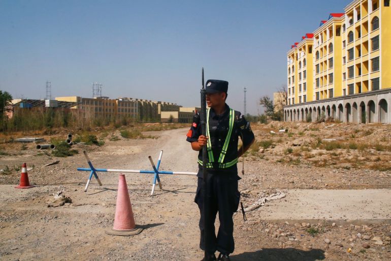 A Chinese police officer takes his position by the road near what is officially called a vocational education centre in Yining in Xinjiang Uighur Autonomous Region, China September 4, 2018. Picture taken September 4, 2018. To match Special Report MUSLIMS-CAMPS/CHINA REUTERS/Thomas Peter