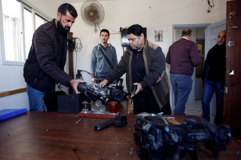Palestinians inspect damaged equipment inside the office of Palestine TV, in Gaza City January 4, 2019. REUTERS/Ahmed Zakot