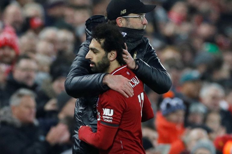 Soccer Football - Premier League - Liverpool v Crystal Palace - Anfield, Liverpool, Britain - January 19, 2019 Liverpool's Mohamed Salah is embraced by manager Juergen Klopp after being substituted off REUTERS/Phil Noble EDITORIAL USE ONLY. No use with unauthorized audio, video, data, fixture lists, club/league logos or