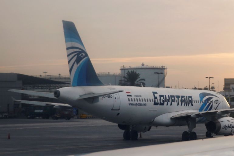 An EgyptAir A320 plane is pictured through the window of an Etihad Airways plane after it landed on the runway at Cairo International Airport, Egypt December 16, 2017. Picture taken December 16, 2017. REUTERS/Amr Abdallah Dalsh