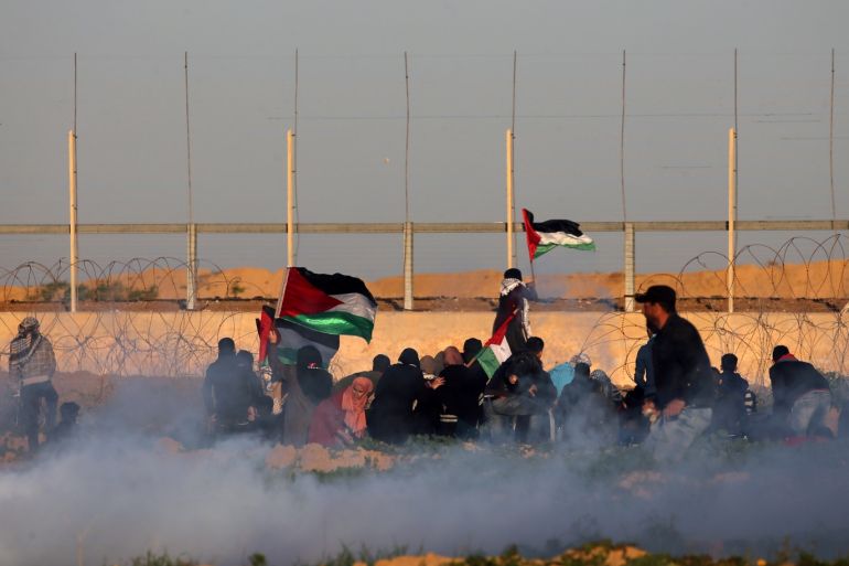 Palestinians protest at the Israel-Gaza border fence as tear gas is fired by Israeli forces, in the southern Gaza Strip January 11, 2019. REUTERS/Ibraheem Abu Mustafa