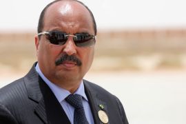 Mauritania's President Mohamed Ould Abdel Aziz waits for the arrival of the French President at Nouakchott airport, Mauritania, July 2, 2018. Macron, making an exceptional appearance at an African Union (AU) summit, was expected to discuss hurdles facing a five-nation French-backed anti-terror unit, the