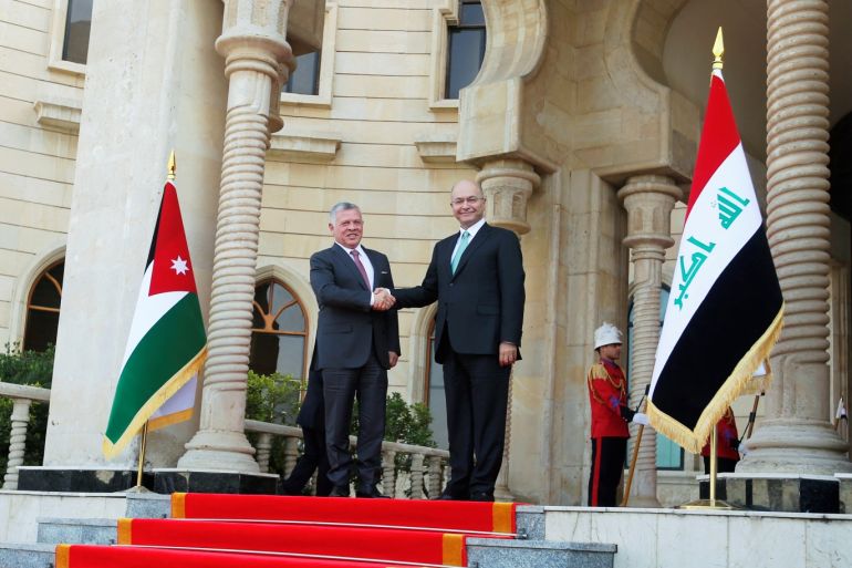 Jordan's King Abdullah shakes hands with Iraq's President Barham Saleh, during his visit in Baghdad, Iraq January 14, 2019. REUTERS/Khalid Al-Mousily