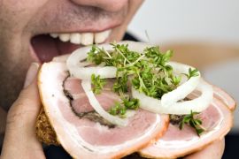 A man eats Rullepolse, a popular type of cold cut that means rolled sausage in Danish, in this undated file photo and received by Reuters on August 12, 2014. An outbreak of listeria tied to contaminated Danish meat Rullepolse has killed 12 people since September last year, with most of the deaths coming in the past three months, Danish health authorities said on Tuesday. REUTERS/Nils Meilvang/Scanpix Denmark/Files (DENMARK - Tags: HEALTH FOOD) ATTENTION EDITORS - THIS IMAGE HAS BEEN SUPPLIED BY A THIRD PARTY. IT IS DISTRIBUTED, EXACTLY AS RECEIVED BY REUTERS, AS A SERVICE TO CLIENTS. DENMARK OUT. NO COMMERCIAL OR EDITORIAL SALES IN DENMARK. NO COMMERCIAL SALES