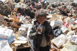 A boy drinks expired juice on a pile of rubbish at landfill site on the outskirts of Sanaa, Yemen November 16, 2016. REUTERS/Mohamed al-Sayaghi